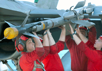 Sailors loading a Sidewinder missile on an aircraft