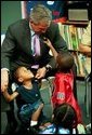 During a tour of Highland Park Elementary School in Landover, Md., President George W. Bush plays with children at the school's Head Start Center where he discussed strengthening America's Head Start Program Monday, July 7, 2003. White House photo by Paul Morse.