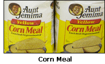 Photograph of two bags of corn meal on the shelf in a grocery store.