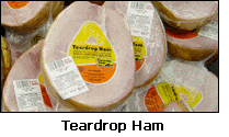 Photograph of teardrop hams in a grocery store.