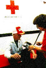 Photo of a person taking the blood pressure of an old man