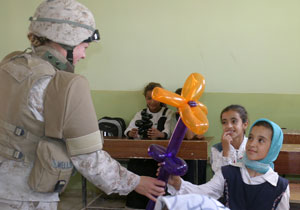 Sgt. Cassondra Wells of the 24th Marine Expeditionary Unit hands a flower balloon to an Iraqi schoolgirl during an Oct. 16th visit to an elementary school in south-central Iraq. The visit was the latest in the MEU’s ongoing Back to School campaign, a key feature of which provides local Iraqi schoolchildren with water, stickers, balloons, sports equipment, and backpacks full of educational supplies.
Wells, 21, is a Rochester, Pa., native and data chief with the Headquarters Detachment of MEU Service Support Group 24. 
The 24th MEU is currently conducting security and stability operations in the Northern Babil province.
(Official USMC photo by Lance Cpl. Sarah A. Beavers. This photo is cleared for release.)
 Photo by:Lance Cpl. Sarah A. Beavers