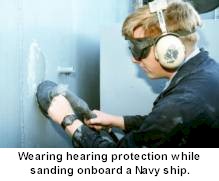 Wearing hearing protection while sanding onboard Navy ship