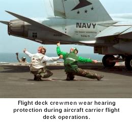 Navy enlisted personnel wear hearing protection during aircraft carrier flight deck operations