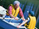 image of older adult and child rowing a boat