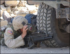 A Soldier from the 14th Infantry Regiment (Light), 25th Infantry Division, prepares to return fire on the enemy with his M4 Carbine and M203 Grenade Launcher, during fighting in Samarra, Iraq.     This photo appeared on www.army.mil.