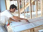 Photo of Eric Newhouse of IBACOS working on a new home.