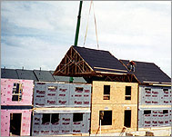 Photo of a row of townhomes under construction.