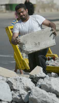 iraqi worker moves material