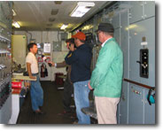 Television crew interviewing merchant mariner aboard ship.