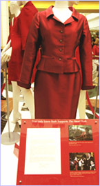 Image of a letter from First Lady Laura Bush along with her Oscar de la Renta red suit