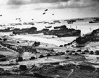 Photo # 26-G-2517:  Landing ships put cargo ashore at low tide, during the first days of the invasion of Normandy, June 1944.