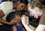 Capt. Carrie Schmid examines the mouth of a Honduran child during medical readiness training.