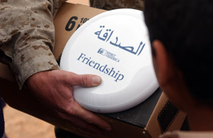 An Iraqi boy accepts a frisbee from 2nd Lt. Robert L. Nofsinger, civil affairs officer for 3rd Battalion, 11th Marine Regiment, 1st Marine Division. The frisbees were donated by the American-based charity Spirit of America. The sporting goods were given out during a soccer game played by residents in Nukhayb, Iraq and artillerymen from the battalion April 6.
(USMC photo by Cpl. Paula M. Fitzgerald) Photo by: Cpl. Paula M. Fitzgerald