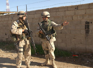 Army Sgt. 1st Class John R. Coomer, from Logan, Ohio and a platoon sergeant for Company C, 3rd Battalion, 505th Parachute Infantry Regiment, speaks with 1st Lt. John E. Pettinelli from Weymouth, Mass., a platoon commander in Company G, 2nd Battalion, 2nd Marine Regiment, 1st Marine Division. Marines are accompanying soldiers on patrols of their operational areas so they can get a feel for the environment and build upon the soldiers' months of experience in dealing with the local population. This is done in the hopes that when the Army turns over their operations during late March, the Marines will be able to pick up the fight seamlessly. (Official U.S. Marine Corps photo by Cpl. Shawn C. Rhodes) Photo by: Cpl. Shawn C. Rhodes