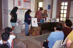 Photo of Promotores providing environmental health education.