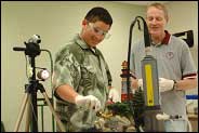 >Photo of Dr. John Hunter, PEER co-investigator, teaching a middle school student.