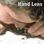 A scientist examines the rock using a hand lens.