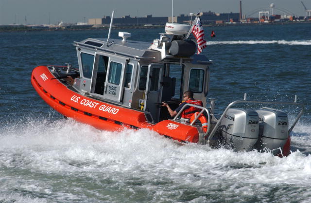 The picture shows a Coast Guard Maritime Safety and Security Team on patrol in the water.
