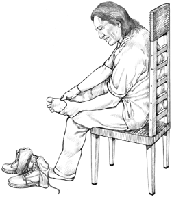 a man sitting down checking his feet
