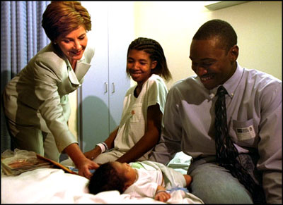 Laura Bush visits with parents Ronnie and Chakeiva Collins, a couple from Plant City, Fla. and their 2-day-old son at Tampa General Hospital on Tuesday, October 1. Mrs. Bush presented the new parents a copy of the Healthy Start, Grow Smart magazine series that provides parents with critical information about the early development, health, nutrition and safety needs of babies and toddlers. White House photo by Susan Sterner.