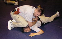 Photograph of NAT practicing his handcuffing technique.