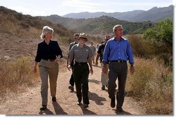 President George W. Bush walks with Secretary of the Interior Gale Norton, left, and Director of the National Park Service Fran Mainella at the Santa Monica Mountains National Recreation Area in Thousand Oaks, Calif. File photo. White House photo by Paul Morse.