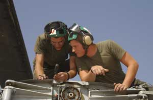 Lance Cpls. John P. Wills (left), a 26-year-old West Virginia native and Wade Sellers, a 19-year-old native of Virginia, airframes technicians, Marine Heavy Helicopter Squadron 361, Marine Aircraft Group 16, 3rd Marine Aircraft Wing, remove a panel on the tail of a CH-53E Super Stallion during a phase maintenance inspection on the flight line at Al Asad, Iraq, Oct. 4. Wills and Sellers are two of the squadron's sixteen phase maintenance Marines that disassemble the aircraft to perform preventative maintenance every 150 flight hours. Photo by: Cpl. Paul Leicht