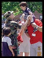 Army Reserve Spc. Brandy Gilliam with Kosovar refugees