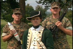 Flanked on the left and the right by Lt. Col. Ned Dachman, from PM Ammunition and Sgt. Drew Tippin, Infantry Weapons Systems, respectively, Maj. Richard Hollen, Infantry Weapons Systems, donned the uniform of a Colonial Marine during the filming of the Marine Corps Systems Command video.  Built around a historical timeline, the video shows off some of the equipment headed for the operating forces. Photo by: Braun Film and Video