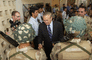 Secretary of Defense Donald H. Rumsfeld shakes hands with Iraqi National Guard members.