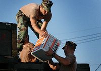 Seabees assigned to Naval Mobile Construction Battalion One (NMCB-1), load chainsaws and other supplies onto a truck headed to Naval Air Station (NAS) Pensacola, Fla. 