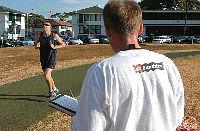 Senior Chief Intelligence Specialist J.T. Ash, Commander, Navy Region Hawaiis command fitness leader, times Chief Journalist Tim Paynters run during that portion of the Spring Physical Readiness Test