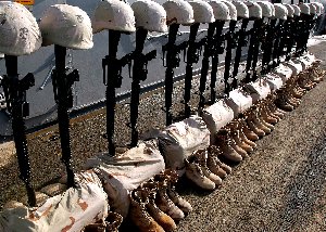 At sea aboard USS KEARSARGE (LHD-3) - 23 sets of helmets, rifles, boots, and dog tags represent 2nd Marine Expeditionary Brigade Marines killed during the Iraqi war. A Memorial Day Service honoring those Marines was held on the flight deck of Kearsarge. 
Photo submitted 05/28/2003 Taken by Petty Officer 2nd Class Alicia Tasz 