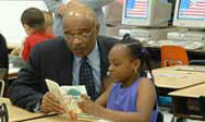Photo of Secretary Paige reading to a child during IEW 2003