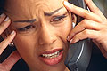 Click to return to Slamming Home Page: Photo of frustrated woman talking on phone