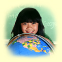 A smiling girl peering over a globe of the world.