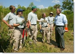 President George W. Bush talks with AmeriCorps volunteers at Rookery Bay National Estuarine Research Reserve in Naples, Fla., Friday, April 22, 2004. "Here at Rookery Bay, you see how important wetlands are to protecting 150 species of birds, and many threatened and endangered animals," said the President in his remarks.  White House photo by Eric Draper.
