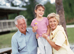 Picture of young boy being hugged by his grandparents