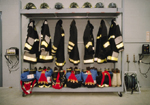 firemen's hats, coats and boots on a rack