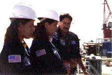 Harjo and Rivera look on as Vasquez explains activities on the production deck.