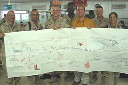 (August 18, 2004) -- Congressman Adam Schiff presents California members of the Armys 1st Calvary Division in Iraq with a banner made by the Asian Youth Center in San Gabriel.