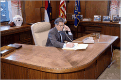 Photo of elected official working at his desk.