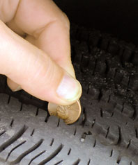 photo of penny placed in tire tread