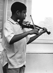 Photo of a boy practicing the violin