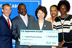 Secretary of Labor Elaine L. Chao (center) presents a $10 million grant to Fred Davie (2nd from left), Vice President of Public/Private Ventures (P/PV), to help ex-offenders make a successful transition to community life and long-term employment. With Secretary Chao are Kevin Gay (far left) President of Operation New Hope; Addie Richburg (second from right), Chief Domestic Strategist, National Association of Blacks in Criminal Justice (NABCJ); and Chakakhan Jones (far right), Ready4Work Program participant.