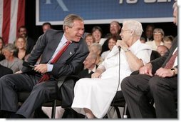 President George W. Bush laughs with senior Wanda Blackmore during a conversation on Medicare-approved prescription drug discount cards in Liberty, Mo., June 14, 2004. White House photo by Paul Morse.