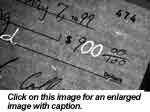 Image of a check with numbers fraudulently added to increase its value. The ink used to write the two zeros in the number "900" is different than the one used to write the remaining entries as revealed through IR luminescence and the VSC2000's integration feature.
