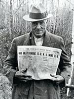 Charles Ross holding the Chicago newspaper.