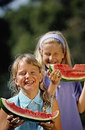 two children eating watermelon